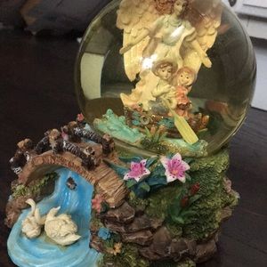 A musical snow globe with angel watching over